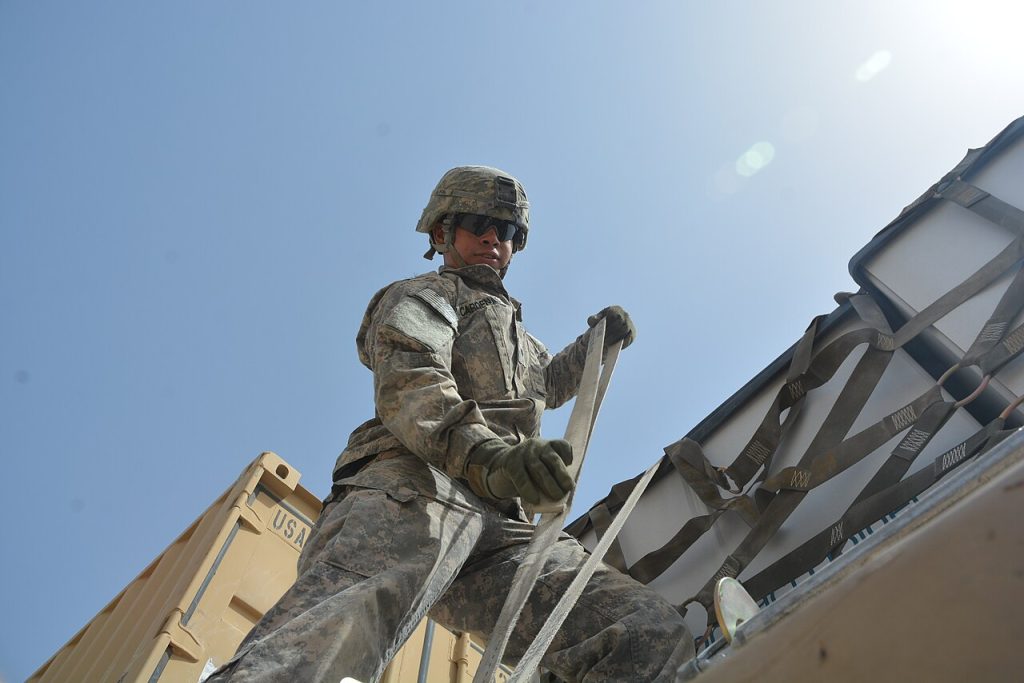 A US Army cargo tie-down activity photographed in 2015. Context only: neither reviewed product nor a civilian cargo arrangement is certified by this image.